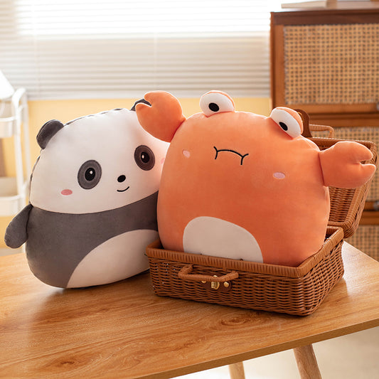 Two cute plush toys, one panda and one crab, in a wicker basket on a wooden table.