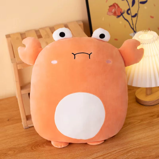 Cute plush toy crab resembling a cartoon character on a wooden surface with a lamp in the background.