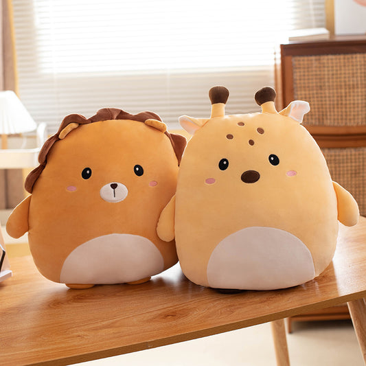 Two cute animal-shaped plush toys, one lion and one giraffe on a wooden surface with a indoor background