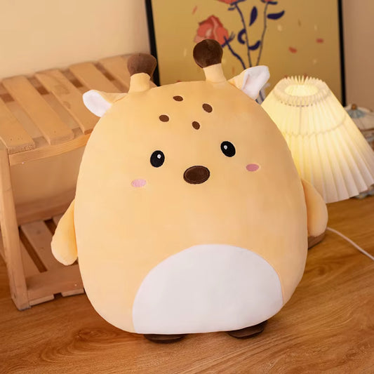 Cute plush toy giraffe on a wooden floor with a lamp in the background